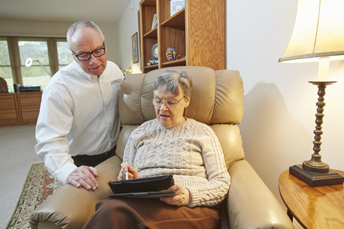 CareConnect Tech Assisting Senior with Tablet